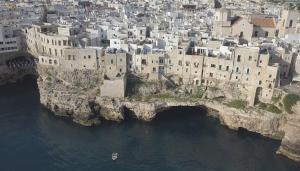 an aerial view of a city on a rocky island in the water at Dimora Talenti in Polignano a Mare