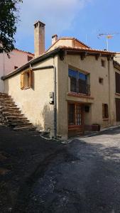 an old building with a staircase in front of it at La carole in Mosset