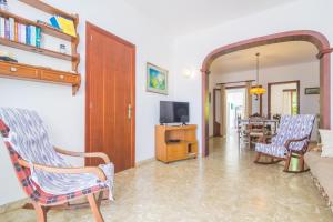 a living room with two chairs and a couch at Casa Tradicional Can Picafort in Can Picafort