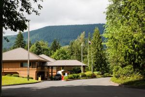 a house with a car parked in a driveway at Mount Hood Village Scarlett Tiny House 3 in Welches