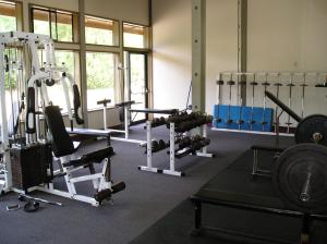 a gym with a lot of equipment in it at Mount Hood Village Atticus Tiny House 8 in Welches