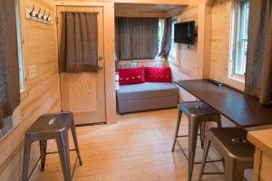 a tiny house with a bench and a table and stools at Mount Hood Village Lincoln Tiny House 2 in Welches