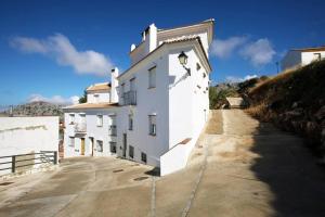 a white building on the side of a road at La Bodeguita in Benaocaz