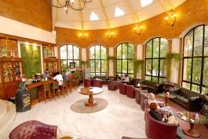 a restaurant with a bar and people sitting in chairs at Park Village Resort by KGH Group in Kathmandu