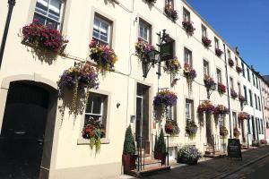 a building with flower boxes on the side of it at Georgian House Hotel in Whitehaven