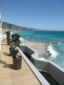 a balcony with a view of the beach and the ocean at Hôtel Riva Art & Spa in Menton