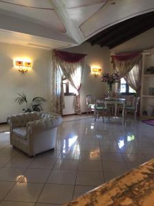 a large living room with a couch and a table at Hotel Terra Di Gallura in Budoni