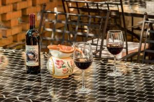 two glasses of red wine sitting on a table at Apartments Lazzarini Battiala in Nedeščina