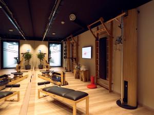 a room with a bunch of pilates equipment at Schwabinger Wahrheit by Geisel in Munich