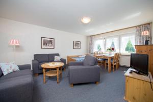 a living room with a couch and a tv and a table at Ferienhof Heins in Undeloh