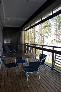 a dining room with a table and chairs on a deck at Kuortaneen Urheiluopisto in Kuortane +64 photos
