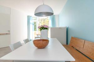 a kitchen with a white table with a bowl on it at Lotsenstieg 2 Kajuete 05 in Ostseebad Karlshagen