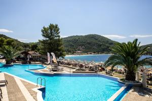 a view of the pool at a resort with a beach at Blue Green Bay in Panormos Skopelos
