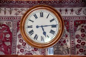 a clock is hanging on a wall at Hotel La Villa della Regina in Gressoney-la-Trinité