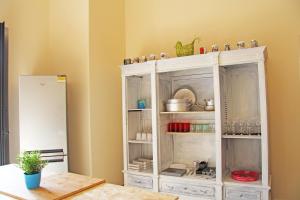 a white cabinet with dishes on it in a room at Urban Pop 2 BnB in Catania
