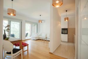 a kitchen and living room with a table and chairs at Aria Apartments in Kotor