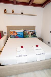 a bed in a room with two boxes on it at Eden Rooms in La Spezia