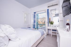 Postel nebo postele na pokoji v ubytování Aegialis Hotel & Spa