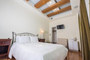 Postel nebo postele na pokoji v ubytování Aegialis Hotel & Spa