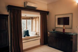 a living room with a window and a television at Devra Udaipur in Udaipur