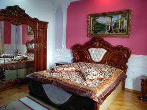 a bedroom with a bed and a mirror at Hotel Royal in Kutaisi