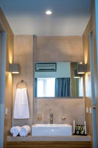 a bathroom with a sink and a mirror at Blue Green Bay in Panormos Skopelos