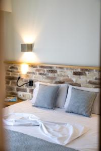 a bedroom with a bed with a brick wall at Blue Green Bay in Panormos Skopelos