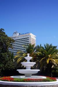 a large white fountain surrounded by palm trees at Sea Galaxy Hotel Congress & Spa in Sochi