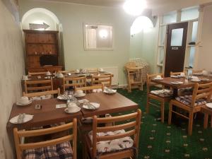 une salle à manger avec des tables et des chaises en bois dans l'établissement Greystones, à Skegness