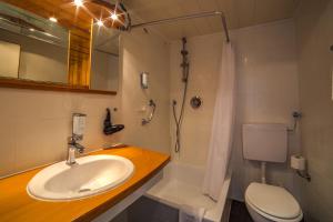 a bathroom with a sink and a toilet and a shower at Hotel Brandl in Bad Wörishofen