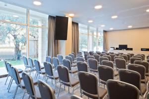 a room with rows of chairs and a podium at Hotel AMI Budva Petrovac in Petrovac na Moru