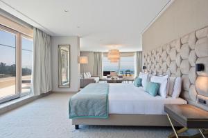 a hotel room with a bed and a view of the ocean at Hotel AMI Budva Petrovac in Petrovac na Moru
