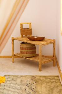 a wooden shelf with a bowl on a table at Tsunami Village in Bwejuu