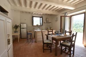 a kitchen with a table and chairs and a refrigerator at Talacchio in Città di Castello