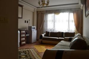 a living room with a couch and a window at Grand Fatih Hotel in Istanbul
