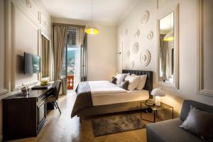 a hotel room with a bed and a couch at Hotel Imperial - Liburnia in Opatija