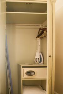 a walk in closet with a white cabinet and a drawer at French Market Inn in New Orleans