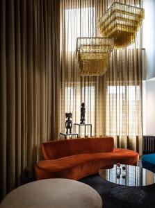 a living room with a couch and a table at AMERON Hamburg Hotel Speicherstadt in Hamburg