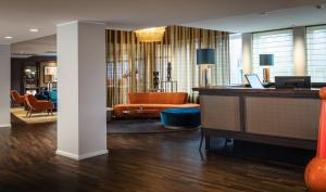 a lobby with a reception desk in a hotel room at AMERON Hamburg Hotel Speicherstadt in Hamburg