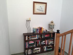 a book shelf filled with books next to a staircase at La Lajita Ocean View in Lajita