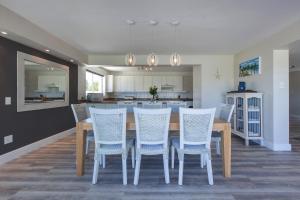 a dining room with a table and chairs and a kitchen at position, Position, POS-ITION! Adjacent CB Beach in Cape Town