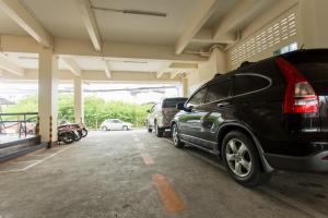 a parking lot with cars parked in a garage at Kulasub Hotel in Hat Yai