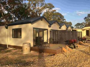 a small house with a deck in a yard at Coonawarra Ensuite Unit A in Coonawarra