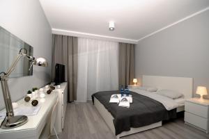Postel nebo postele na pokoji v ubytování Apartament KORNER Chełmońskiego Śrem