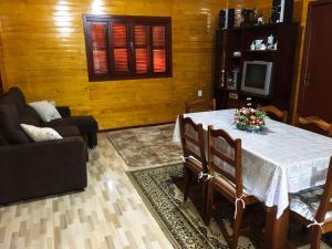 a living room with a table and a couch at Casa de Campo Vale Rio dos Bugres in Urubici