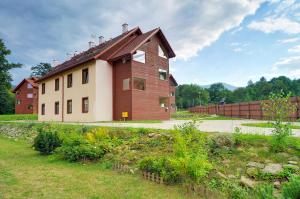 a large house with a fence in front of it at Wrzosowy in Karpacz