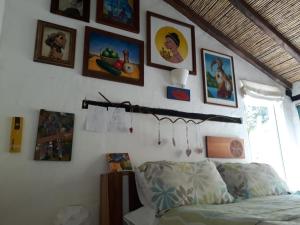 a room with a bed and pictures on the wall at Jacamaki- Eco-lodge & Reserva Natural in Villa de Leyva