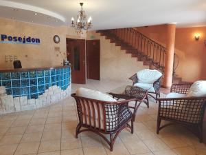 a lobby with chairs and tables and a staircase at Posejdon in Ustronie Morskie