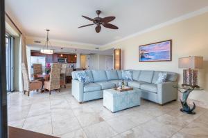 a living room with a blue couch and a table at Honua Kai - Hokulani 509 - Ocean view from INSIDE! 2b/2b in Kaanapali