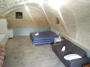 a living room with a couch and a bed at House La Palma in Ruvo di Puglia +44 photos